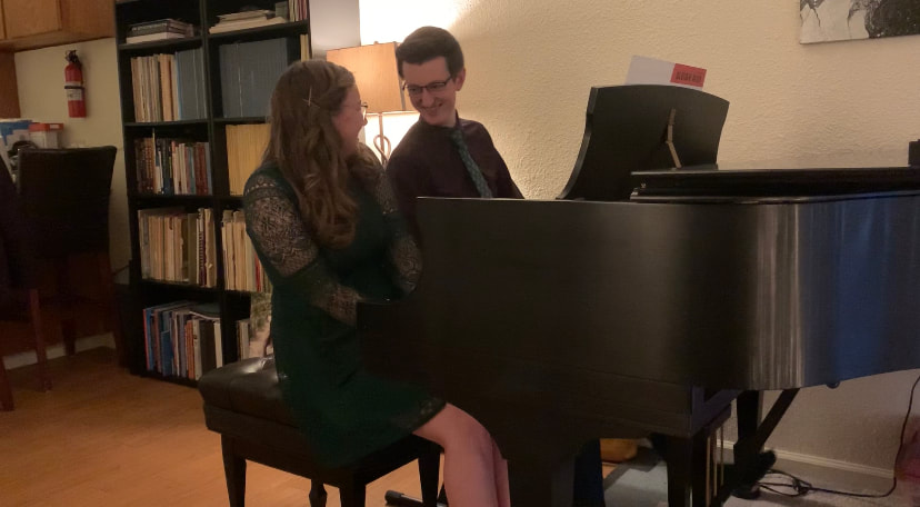 Thomas and Kassidy playing at a grand piano together
