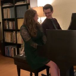 Thomas and Kassidy playing at a grand piano together